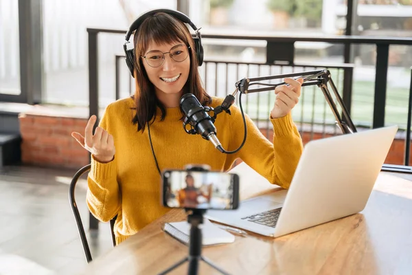 depositphotos_528615700-stock-photo-woman-podcaster-headphones-glasses-looking